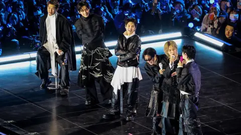 Navigating the Global Stage: BTS's Crossroad between K-Pop Origins and International Fame