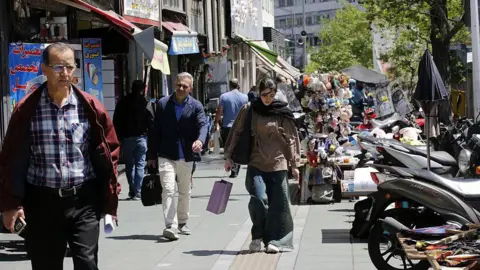 Tehran's Struggles: Life Amidst Economic Hardships and War Threats